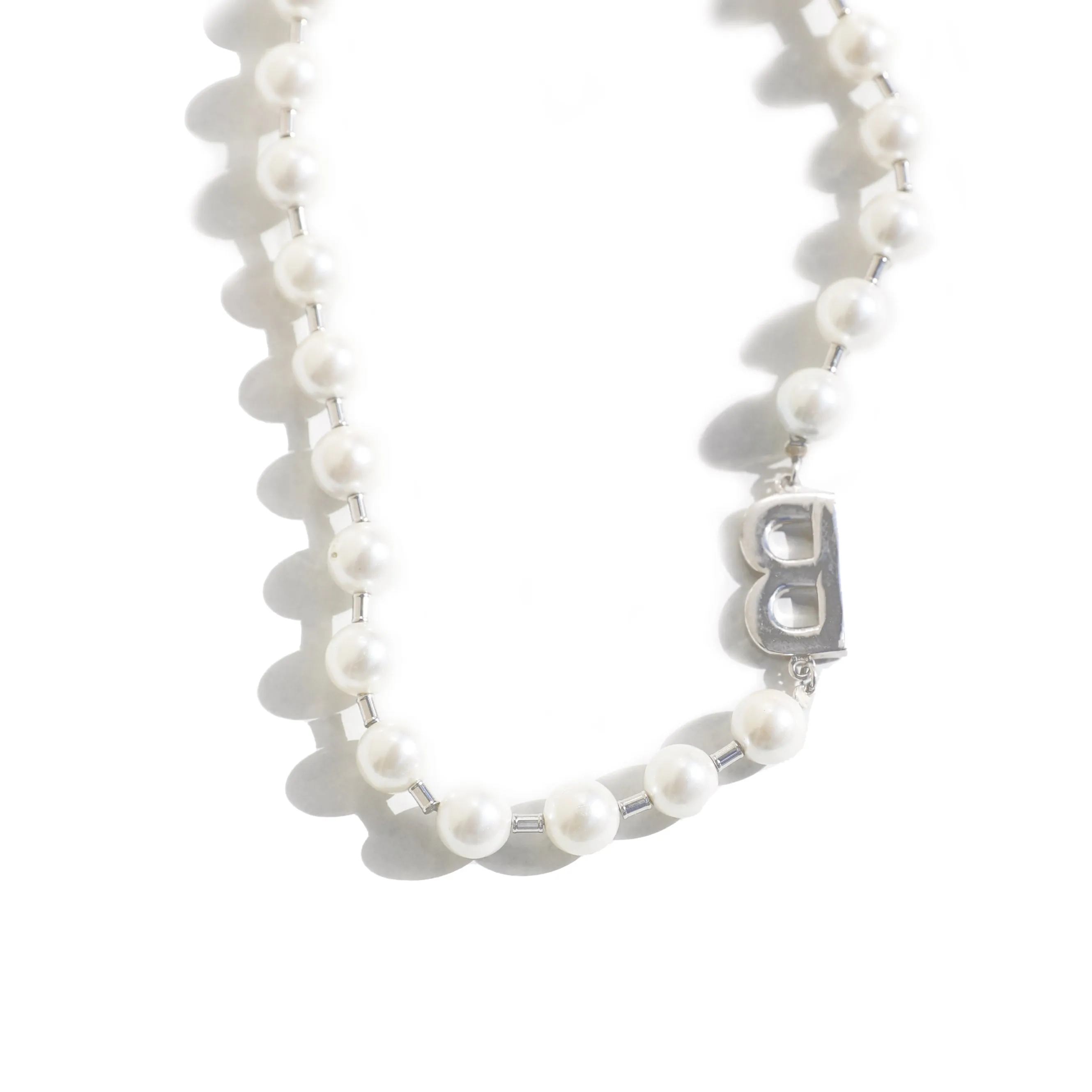 A silver pearl necklace in a classic