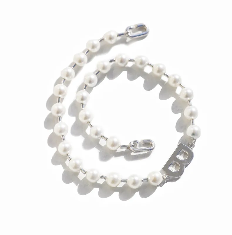 A silver pearl necklace in a classic